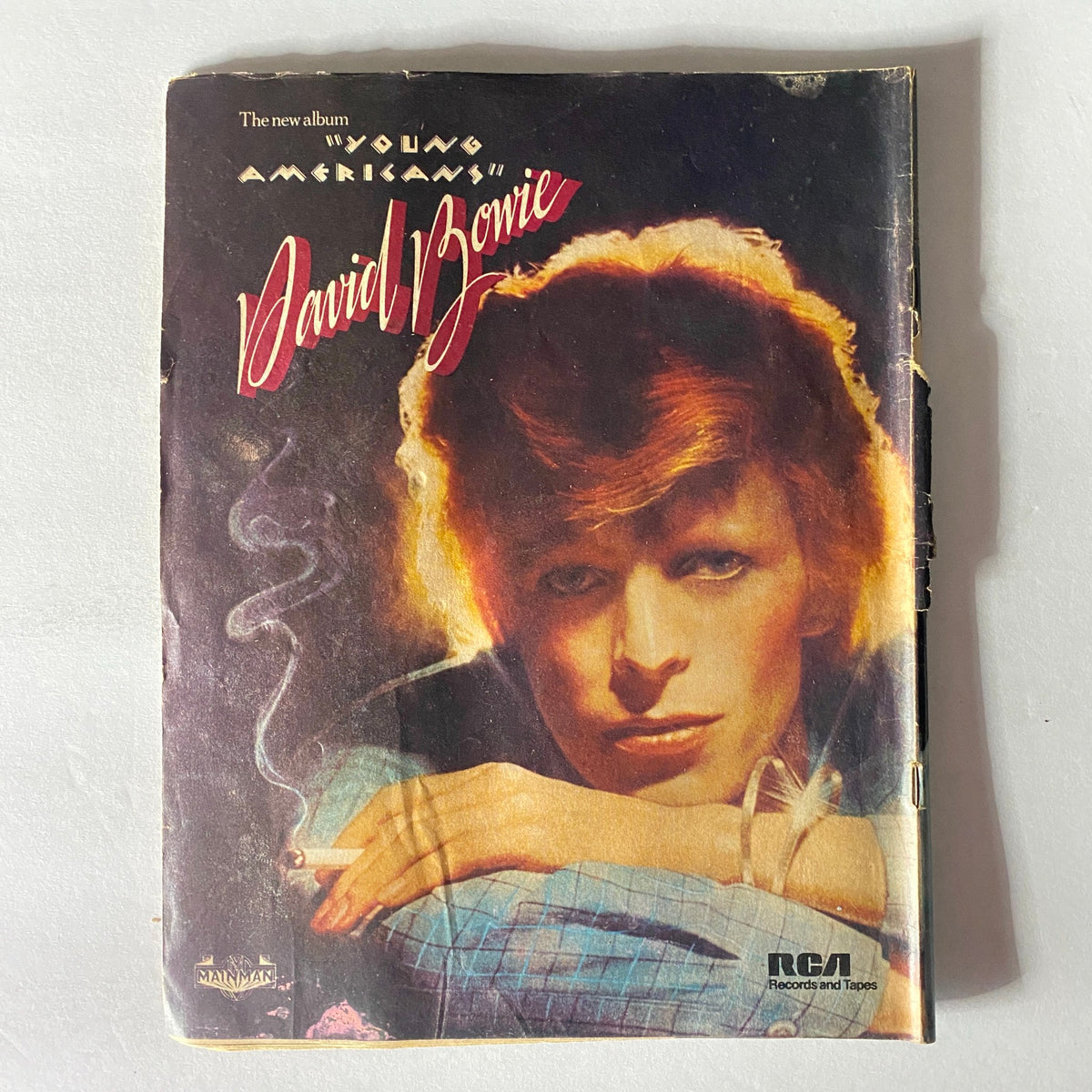 Cover of Circus Magazine May 1975 No. 109 featuring iconic rock artist David Bowie. The image displays a striking portrait of Bowie with a cigarette, emphasizing his unique style and the album 'Young Americans'. A must-have item for collectors and fans of classic rock history.