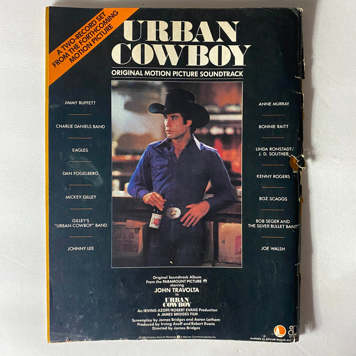 Back cover of the Urban Cowboy soundtrack album featuring John Travolta, showcasing the film's original motion picture soundtrack.