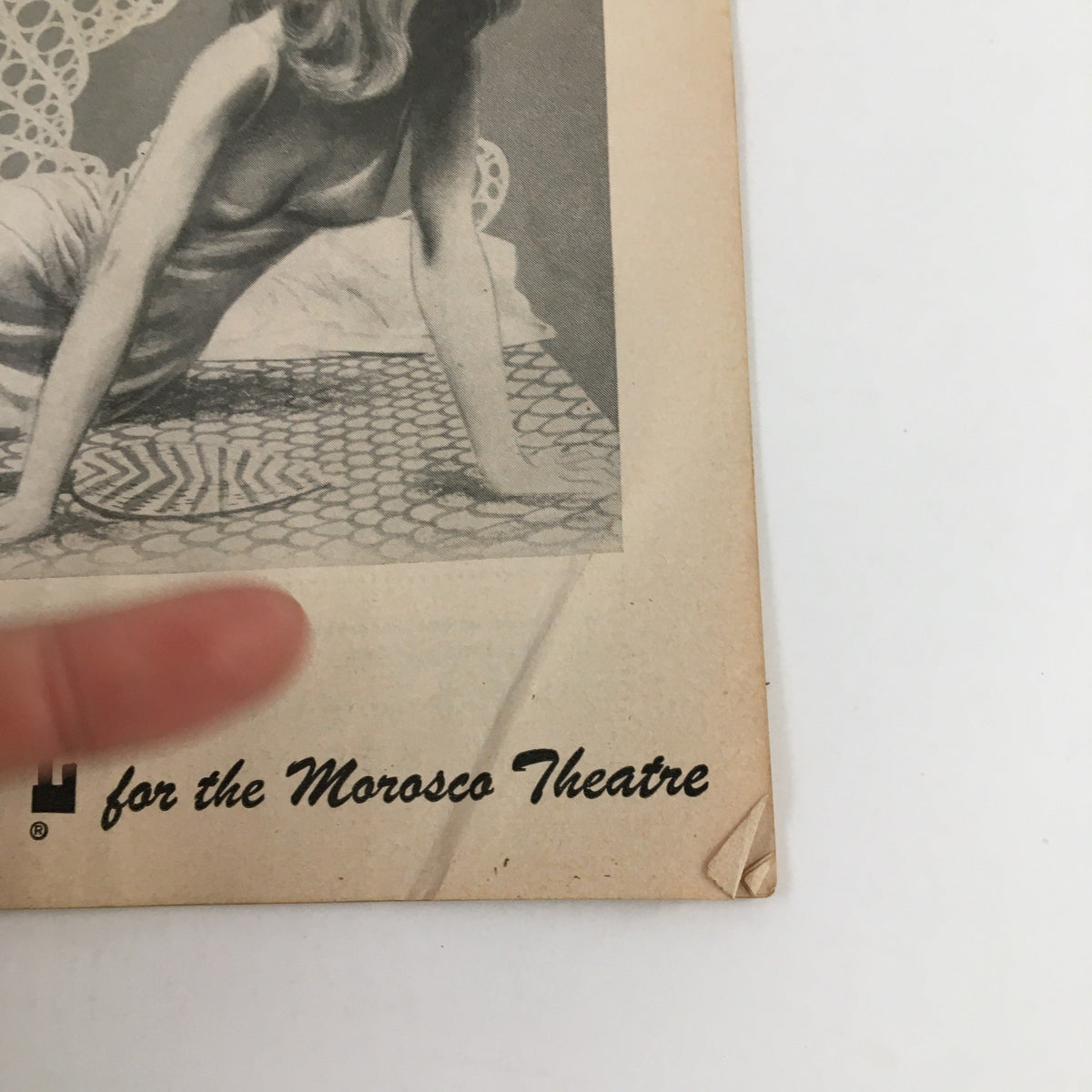Close-up of a vintage 1955 Playbill for Morosco Theatre's production of Cat On A Hot Tin Roof by Tennessee Williams, featuring an artistic image of a woman.