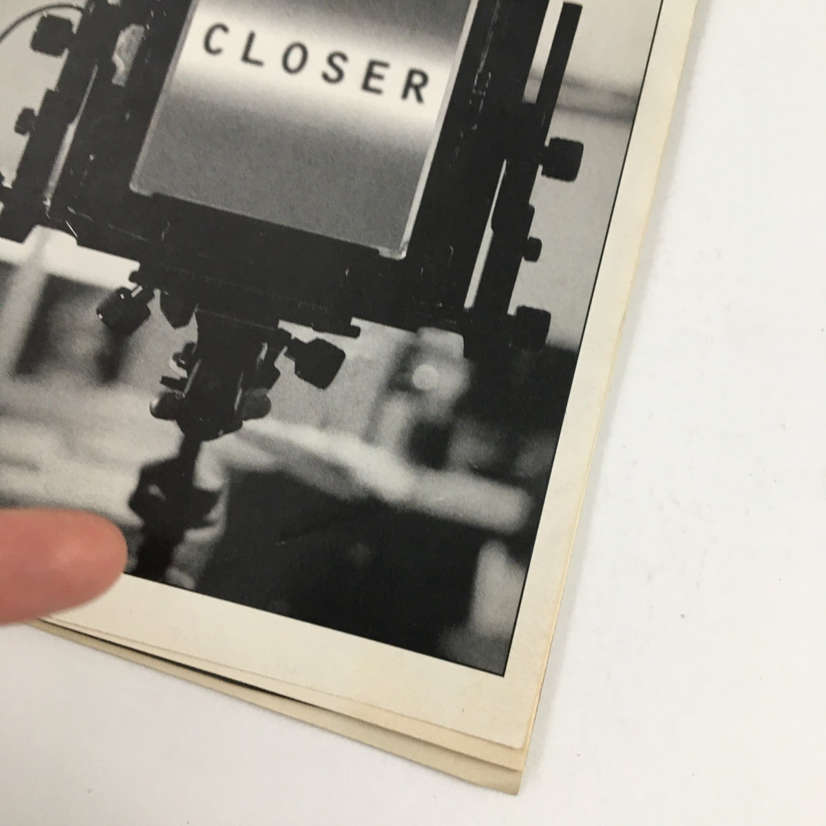Close-up view of the 1999 Playbill for The Music Box Theatre's Closer, emphasizing the title 'CLOSER' on a vintage stage camera, an iconic representation of the production featuring Natasha Richardson.