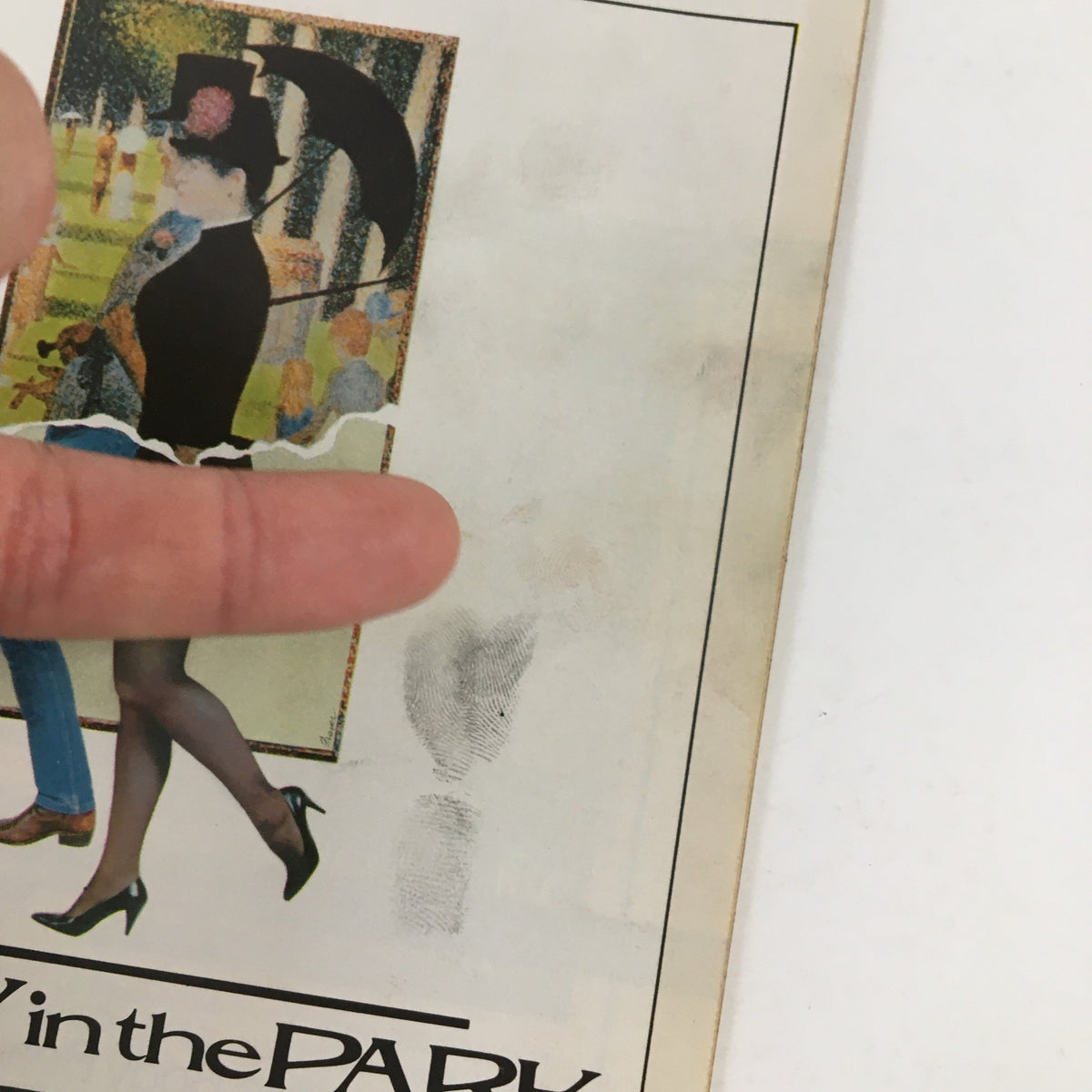 Close-up of the 1984 Playbill for 'Sunday In The Park With George,' highlighting the iconic cover design with a woman in a chic outfit, set against a colorful backdrop of park scenery.