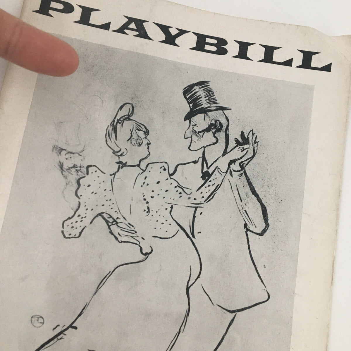 Close-up of the 1957 Playbill for Romanoff and Juliet highlighting the artistic illustration of dancers, representing vintage theater memorabilia.