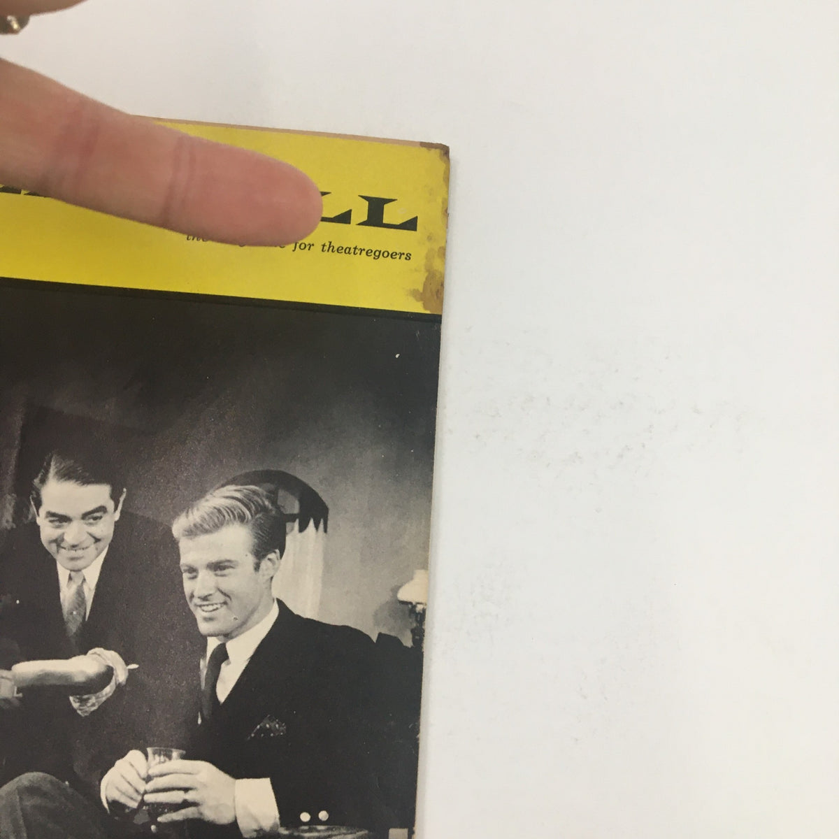 Close-up of the 1964 Playbill for Barefoot In The Park, highlighting the title and the top edge of the magazine with slight wear, presenting its vintage character.