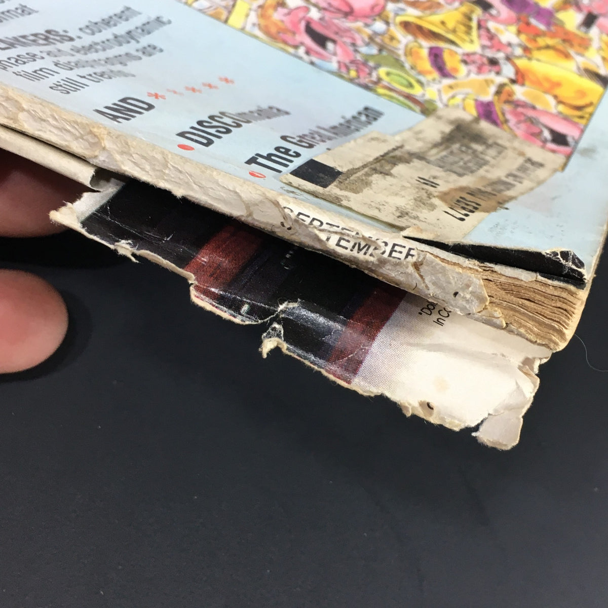 Side view of the Vintage Stereo Review Music Magazine September 1976 displaying signs of wear and tear, highlighting its vintage condition.