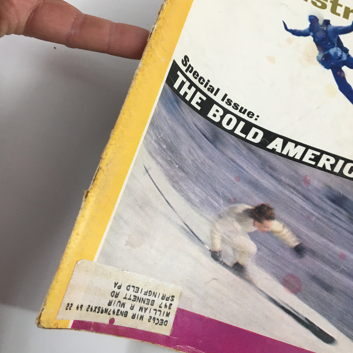 Side view of the Sports Illustrated Magazine December 24, 1962, highlighting 'The Bold American Issue' label and showing wear consistent with its age.
