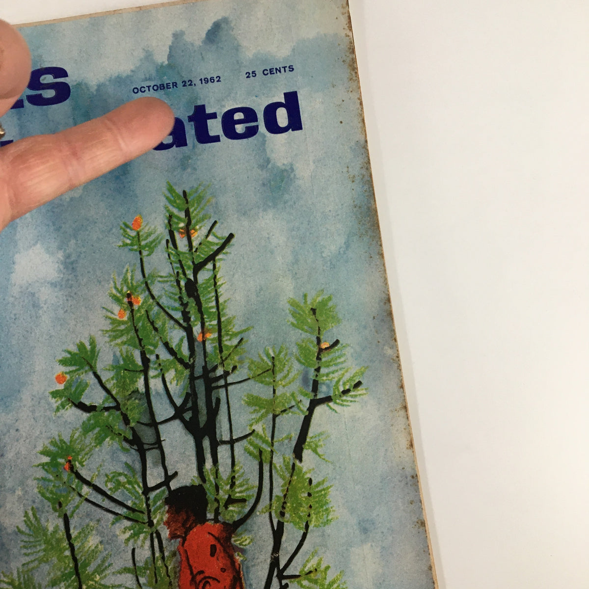 Close-up of the vintage Sports Illustrated magazine cover dated October 22, 1962, highlighting the title 'Big Game Hunting in Idaho' and displaying a finger pointing at the date and price.