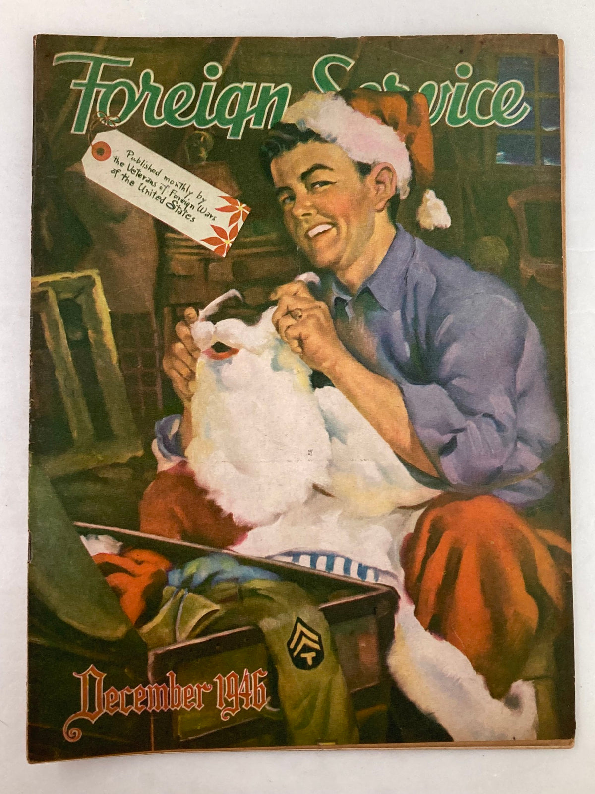 Cover of VTG Foreign Service Magazine December 1946 Vol 34 #4 featuring a young man in a Santa hat, sewing a Santa suit, highlighting festive themes and post-war societal issues.