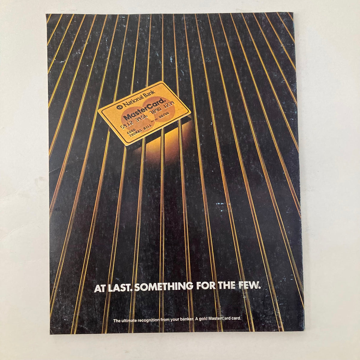 Back cover of the January 1984 Vanity Fair magazine, displaying an advertisement for a gold MasterCard with a sleek design, emphasizing luxury and exclusivity.