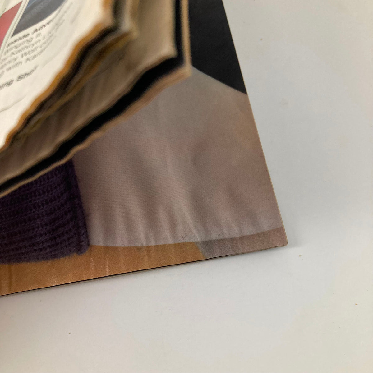 Close-up view of the American Photographer Magazine November 1984 showcasing the edge of the pages, highlighting its vintage condition.