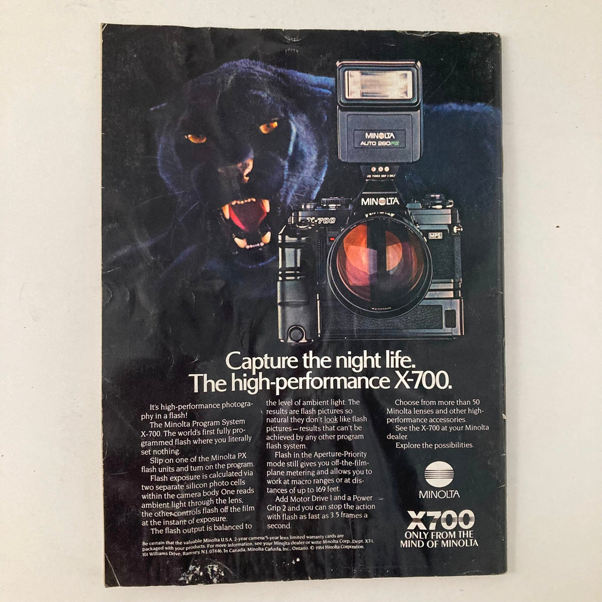 Back cover of the American Photographer Magazine November 1984 featuring an advertisement for the Minolta X-700 camera, emphasizing photography in the 1980s.