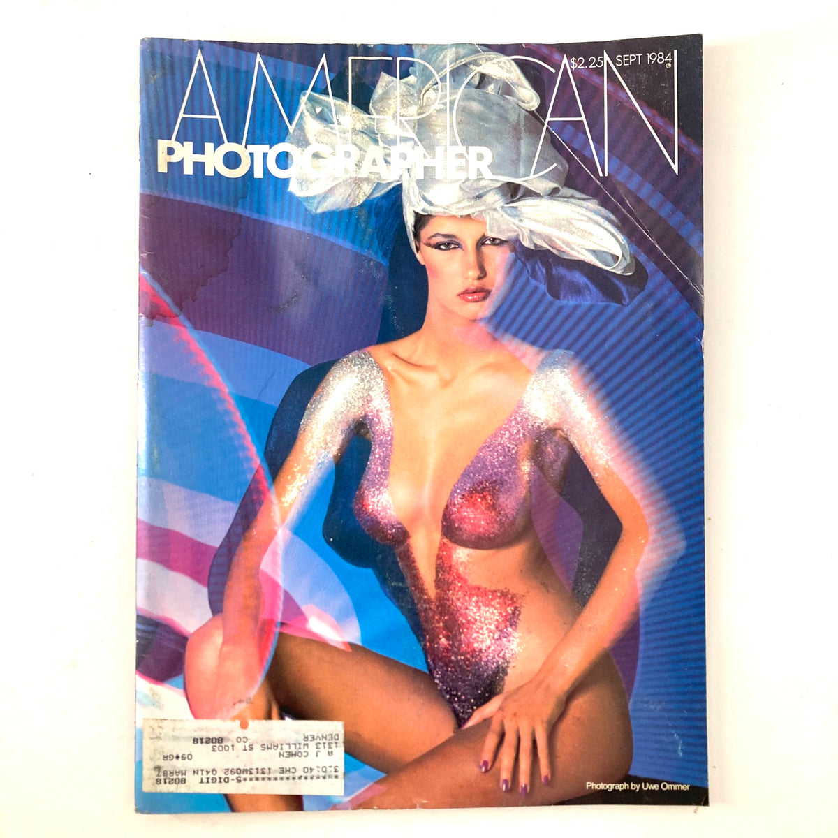 Cover of American Photographer Magazine September 1984 featuring a striking image of a model with glitter, photographed by Uwe Ommer. This vintage magazine showcases the artistry of photography from the 1980s.