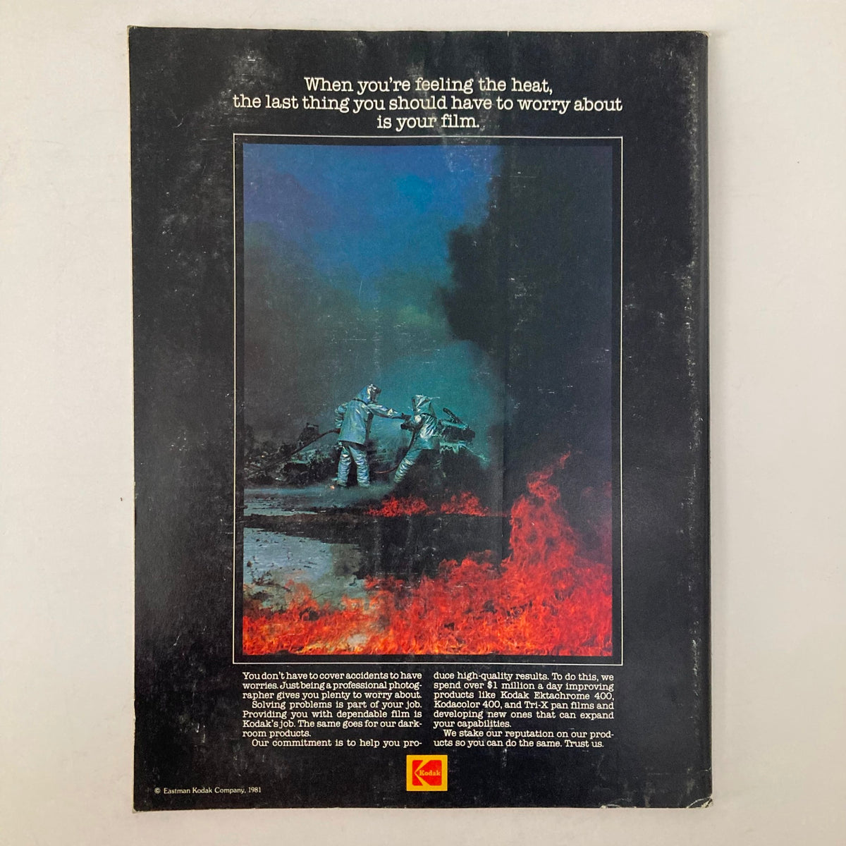 Back cover of American Photographer Magazine March 1981 featuring an advertisement by Kodak, emphasizing film reliability for professional photographers, set against a striking image with firefighters.