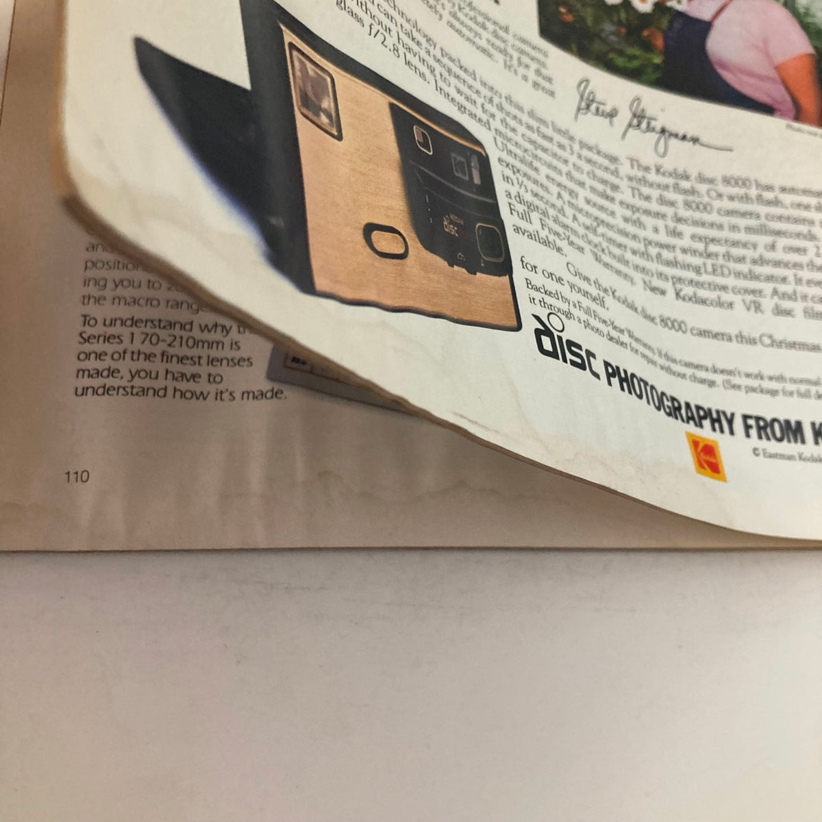 Close-up of an advertisement for Kodak disc photography from American Photographer Magazine December 1983, highlighting camera features and photography testimonials.