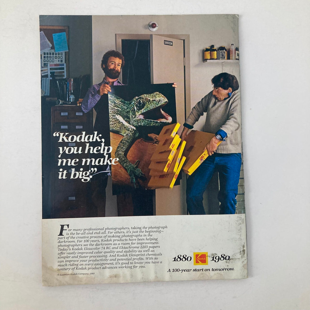 Back cover of American Photographer Magazine November 1980, showcasing a Kodak advertisement with a photographer holding a large poster.