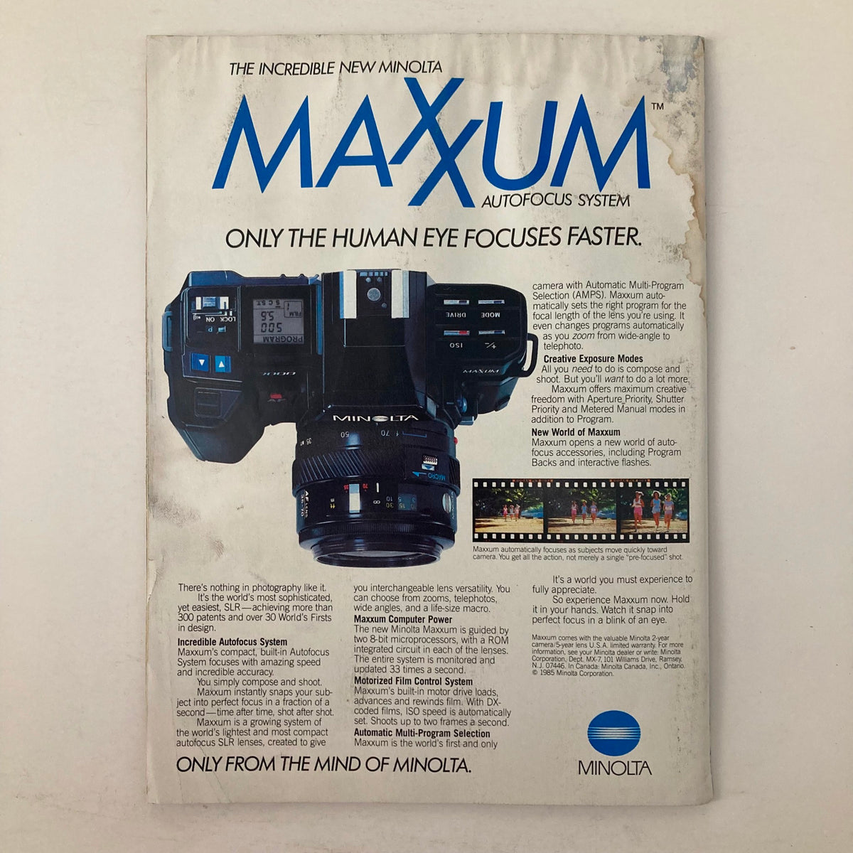 Back cover advertisement for the Minolta Maxxum autofocus system featured in American Photographer Magazine April 1985, promoting advanced photography technology.