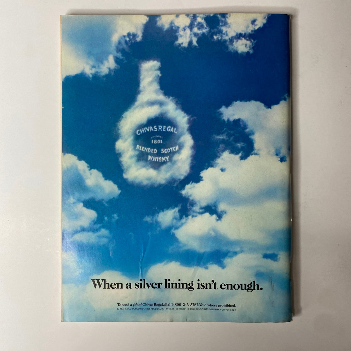 Back cover of Forbes Magazine September 22, 1986 showcasing an advertisement for Chivas Regal blended Scotch whisky with clouds in the background.