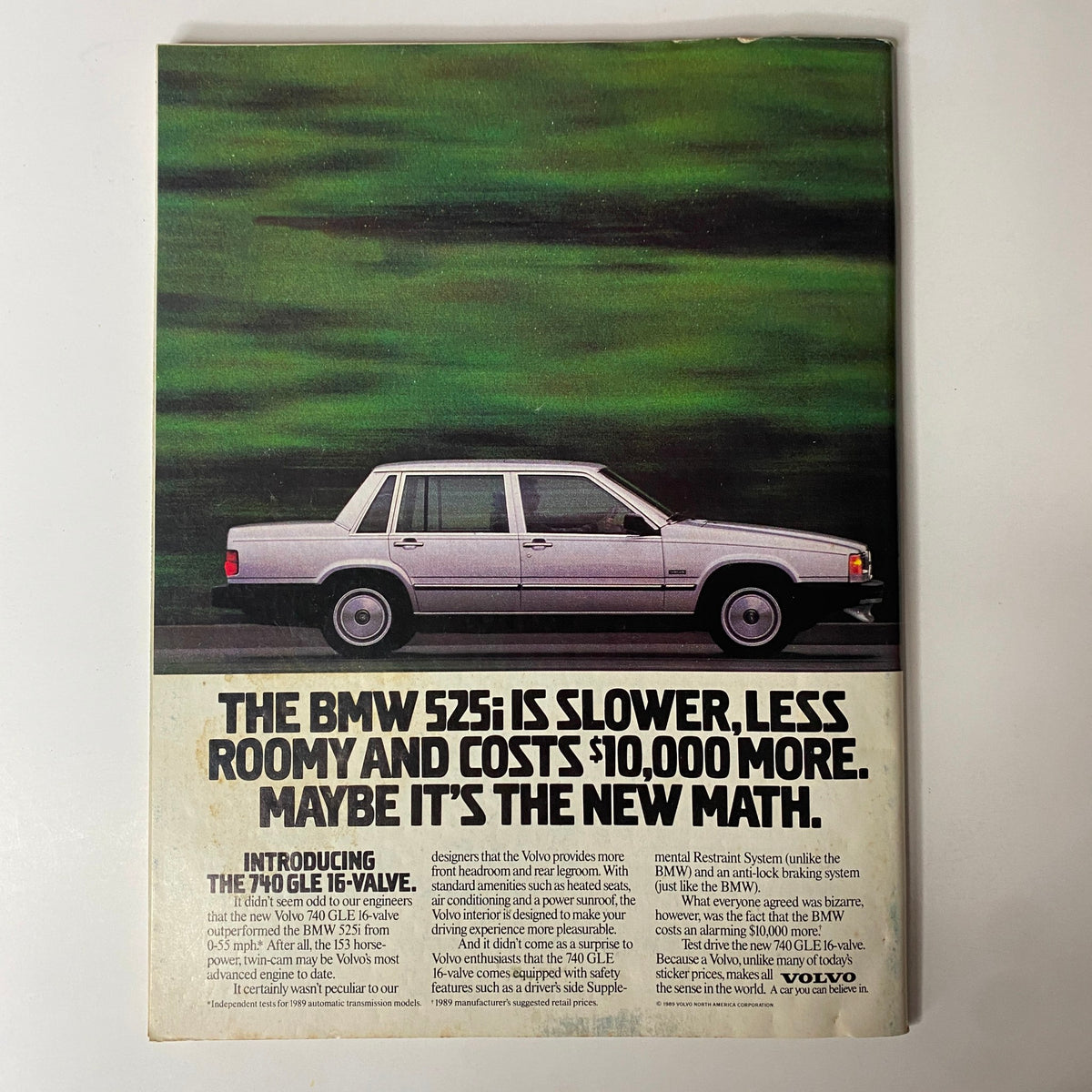Vintage advertisement for the BMW 525i in Forbes Magazine May 15, 1989, comparing it to the Volvo 740 GLE, emphasizing unique features and pricing.