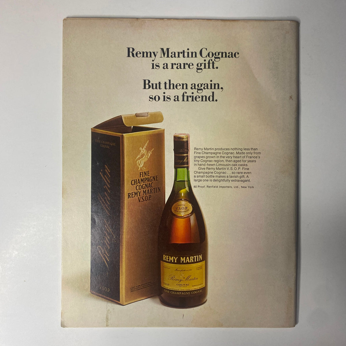 Vintage advertisement for Remy Martin Cognac titled 'Remy Martin Cognac is a rare gift. But then again, so is a friend.' showcasing a bottle and packaging, reflecting its fine quality.