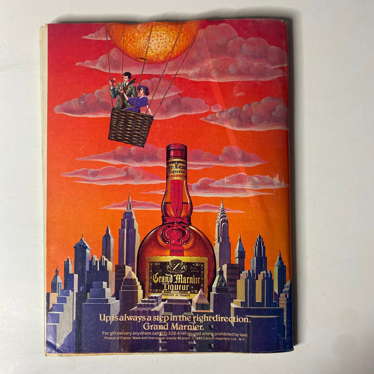 Back cover advertisement of Forbes Magazine dated October 8, 1984, featuring a colorful illustration for Grand Marnier liqueur with a skyline backdrop.