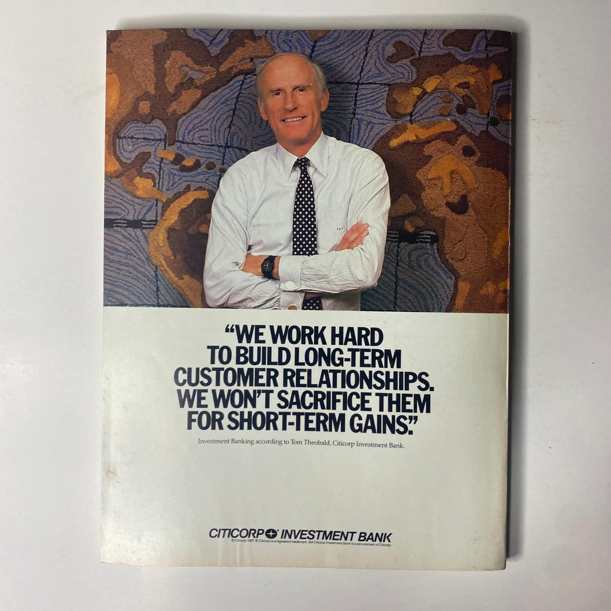 Back cover of Forbes Magazine 1987, displaying a quote about long-term customer relationships from Tom Theobald of Citicorp Investment Bank. The image features a professional man in a suit, emphasizing the importance of building lasting business connections.