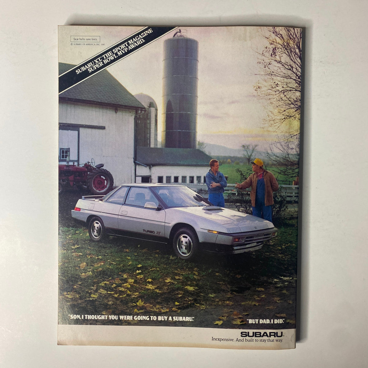 Back cover of Forbes Magazine January 12, 1987 featuring a Subaru advertisement with two individuals discussing a vehicle.