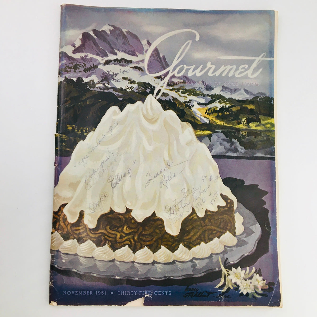 Vintage cover of Gourmet The Magazine of Good Living, November 1951, Volume 11, Issue 11, titled 'To Paint the Lily'. Featuring a decorative cake with a whipped cream topping against a scenic background of mountains and lakes, showcasing the culinary elegance of the 1950s.