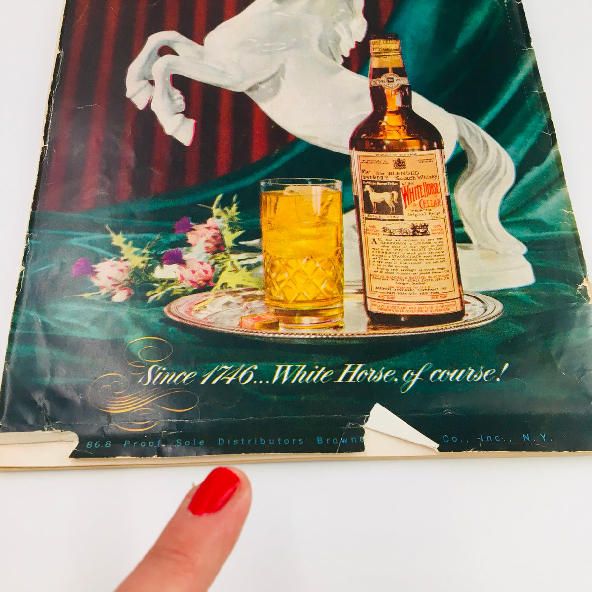 Back cover of Gourmet The Magazine of Good Living November 1951, featuring a decorative bottle and glass, symbolizing the elegant lifestyle of the 1950s.