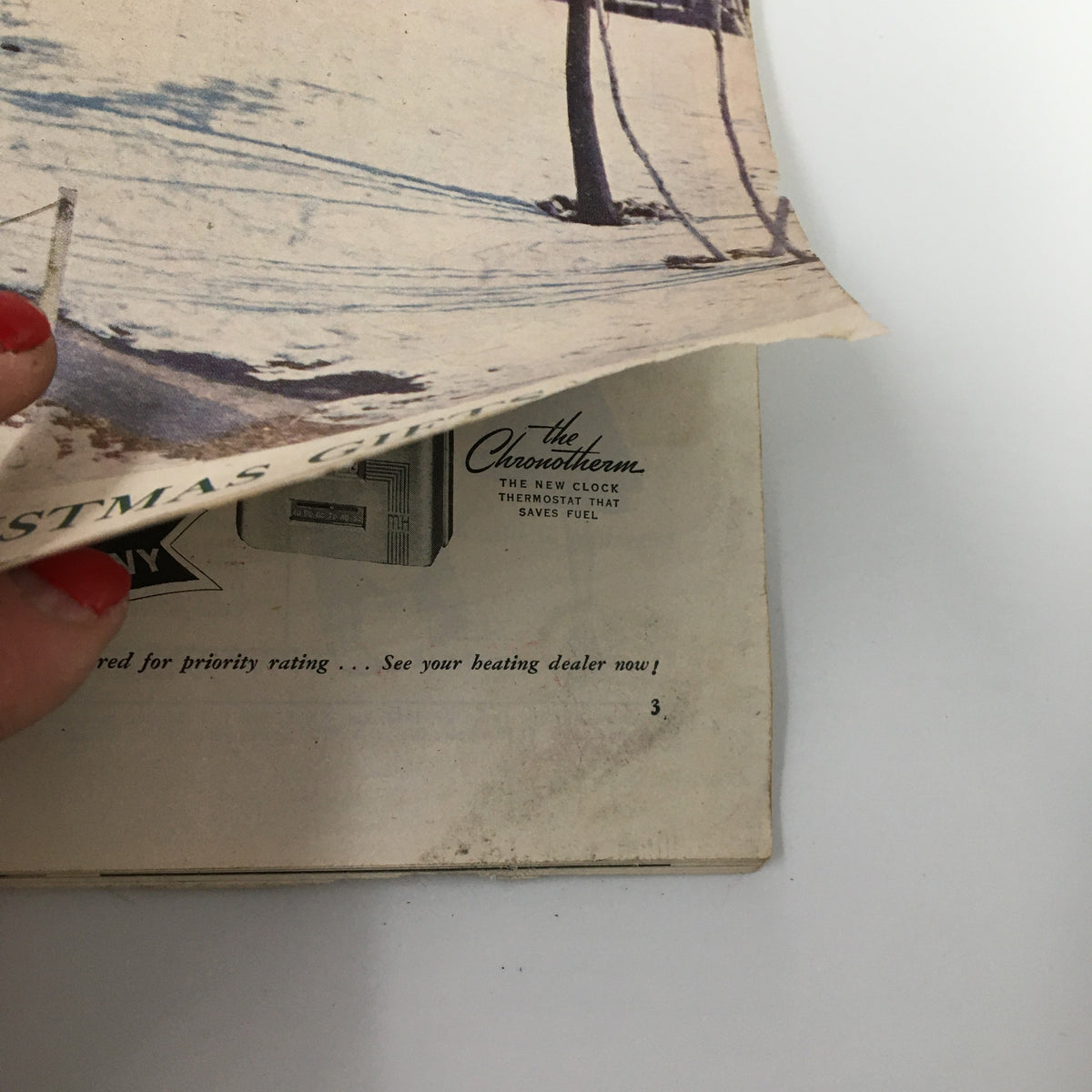 Side view of the front cover of VTG The American Home Magazine December 1942 showing snowy setting and magazine title 'Tomorrow Will Be Christmas Sonny.' Highlights the vintage aesthetic of the era.