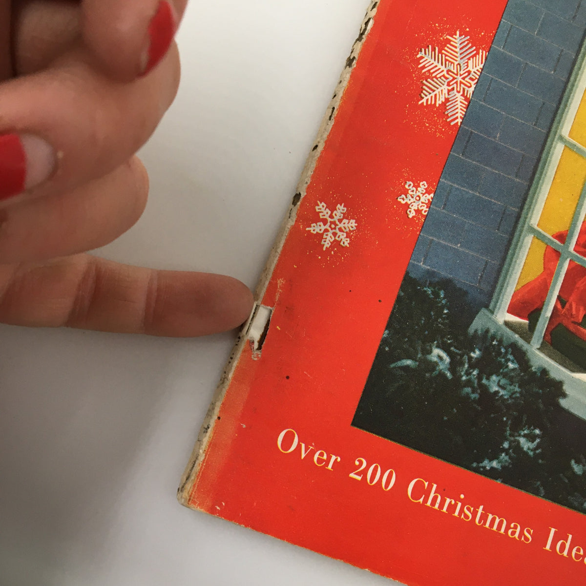 Close-up of the spine of the VTG The American Home Magazine December 1948, showing minor wear and a label, emphasizing its vintage condition and collectible status.