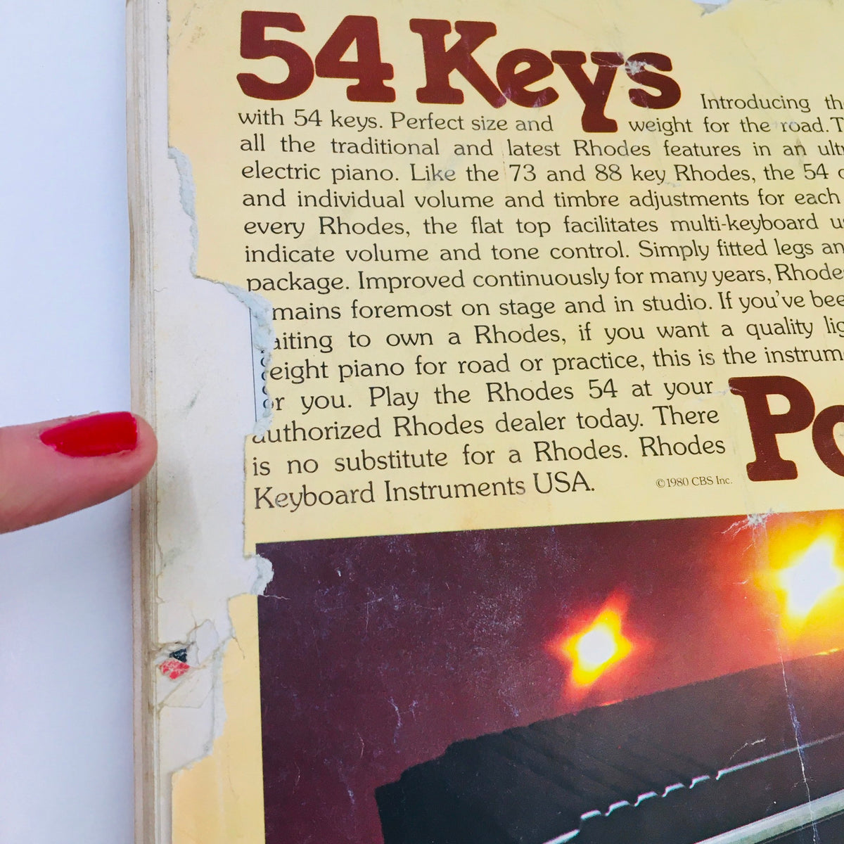 Guitar Player Magazine April 1980 detail image of the Rhodes Stage Piano advertisement, with focus on key specifications and a finger pointing to a ripped section.
