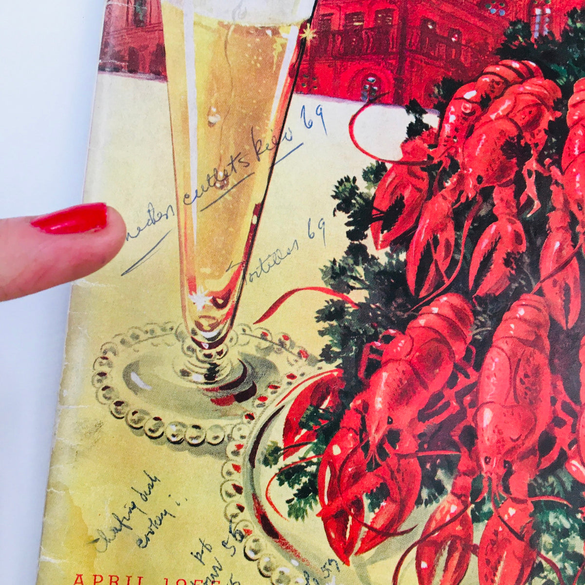 Close-up of the cover of Gourmet Magazine April 1955 Vol 15 #4, highlighting handwritten notes on the festive seafood dish and beer glass.