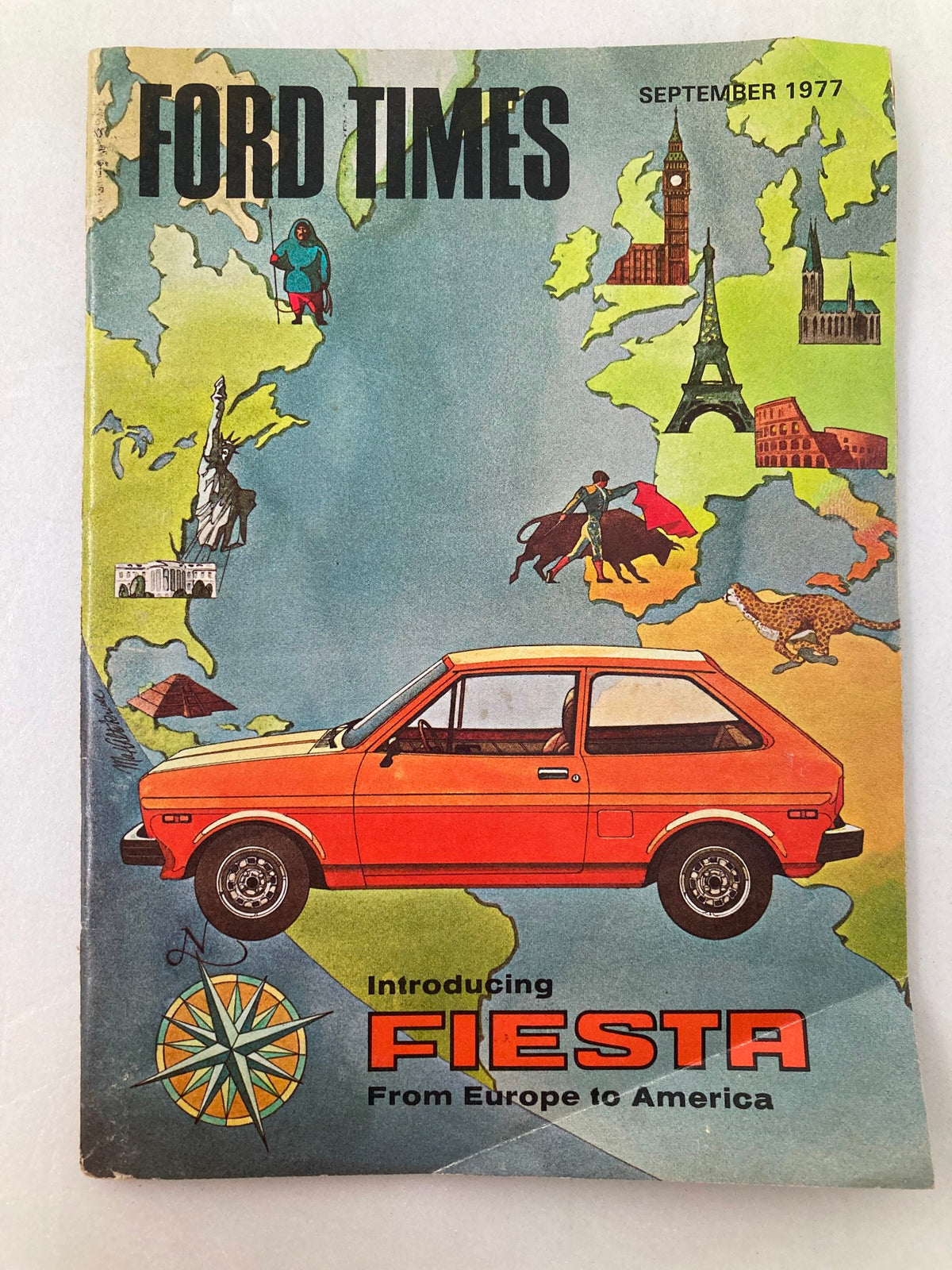 Cover of VTG Ford Times Magazine from September 1977 featuring the Ford Fiesta, highlighting the car's introduction from Europe to America with illustrations of iconic landmarks.