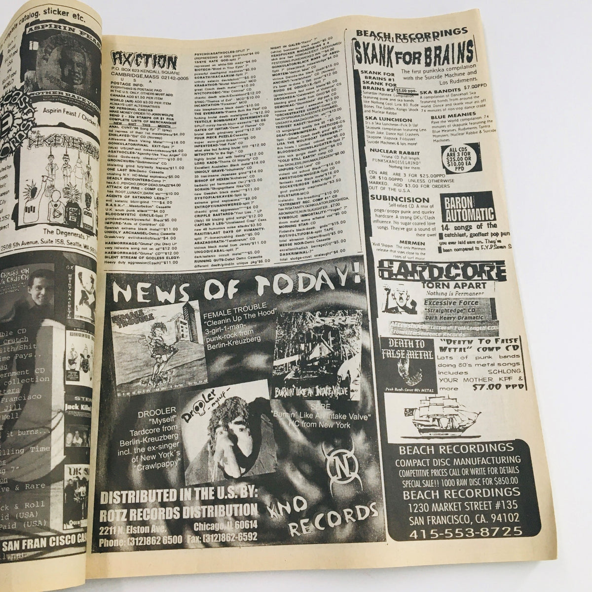 Inside spread of Maximum RocknRoll Magazine December 1997 issue #175 showing advertisements and listings related to punk music and culture.
