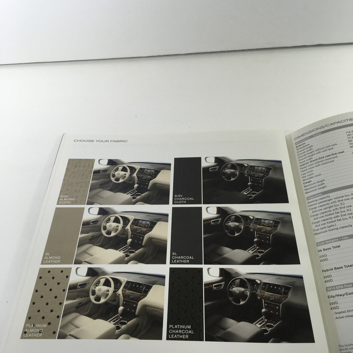 2014 Nissan Pathfinder SUV dealership brochure illustrating interior fabric choices including various leather options and colors.
