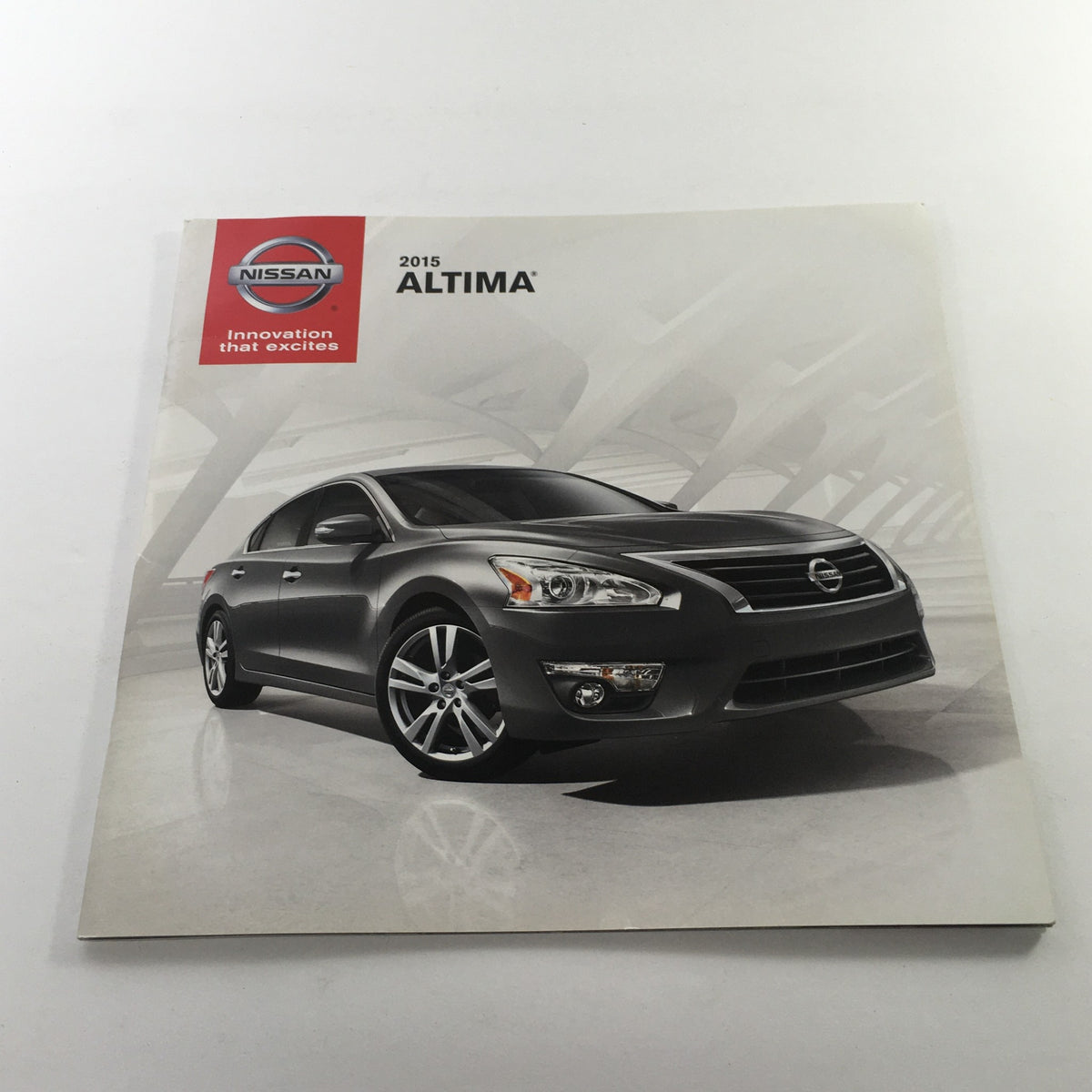 Front cover of the 2015 Nissan Altima Sedan Dealership Car Auto Brochure Catalog showcasing the sleek design of the vehicle.