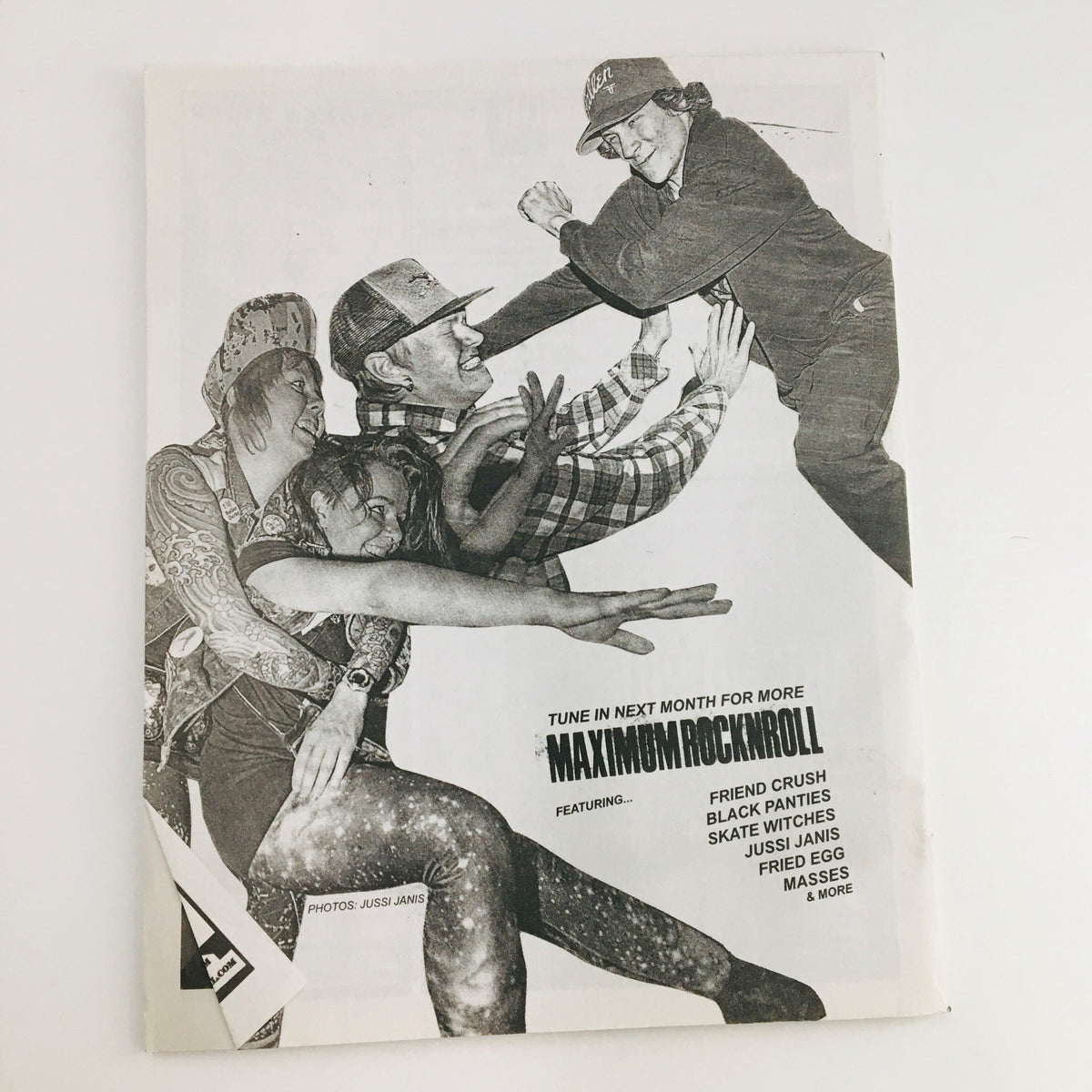 Cover of Maximum RocknRoll Magazine July 2016 #398 featuring dynamic imagery of punk culture. Highlights include a playful interaction among punk fans, illustrating the vibrant community within the Ex-Yugo Punk movement.