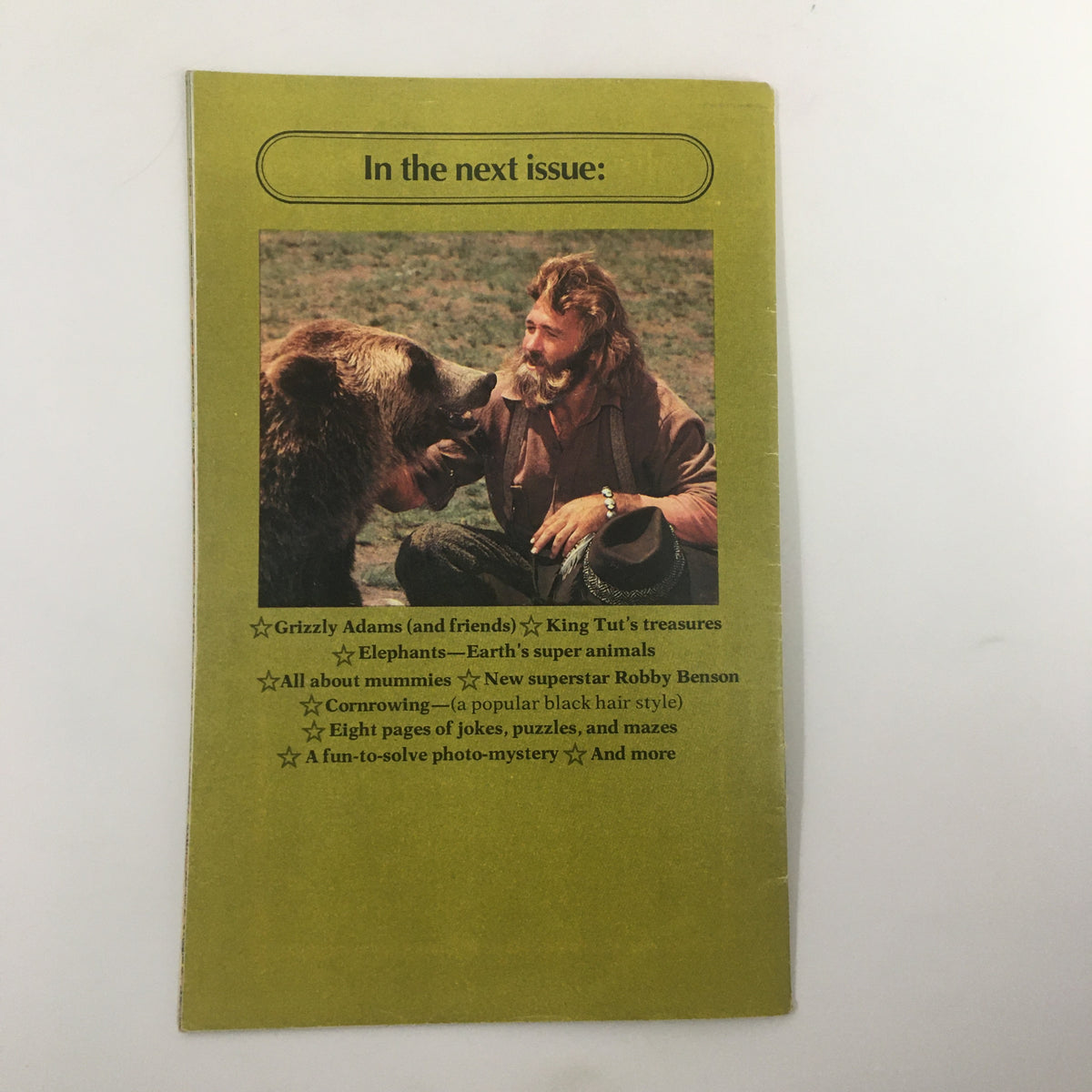 Back cover of VTG SuperMag Magazine 1977 Vol. 2 No. 3 featuring an image of a man with a bear and a preview of upcoming articles including Grizzly Adams, King Tut's treasures, and fun puzzles.