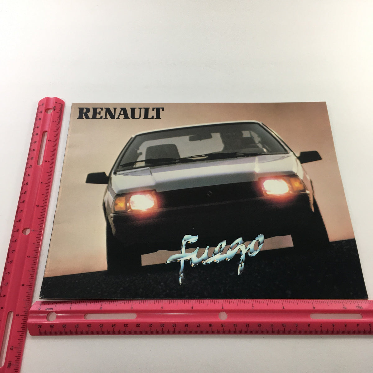 1984 Renault Fuego Turbo Coupe Dealership Car Brochure front cover featuring the Fuego with sleek design and headlights.