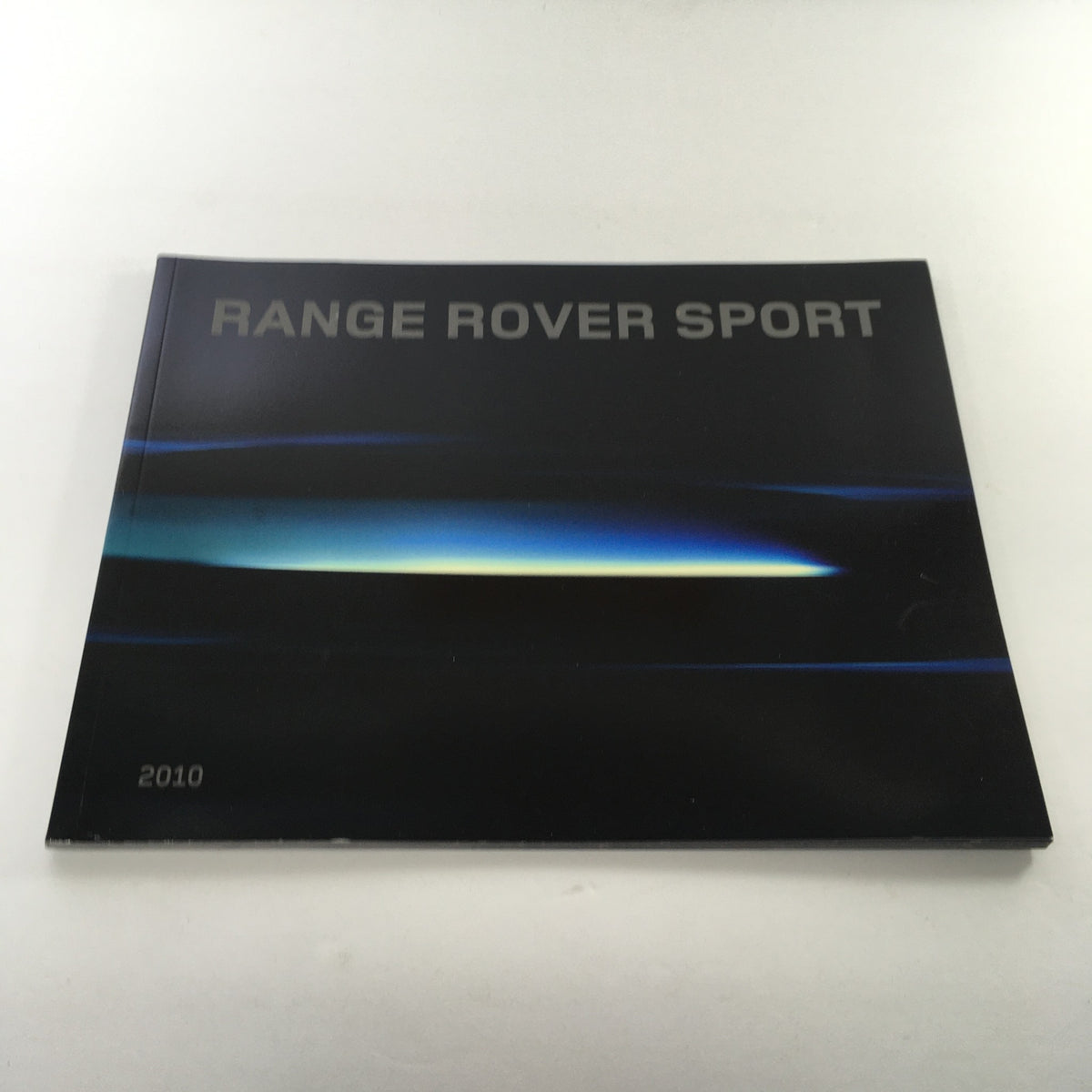 Cover of the 2010 Land Rover Range Rover Sport Dealership Car Auto Brochure Catalog featuring sleek design and modern style.