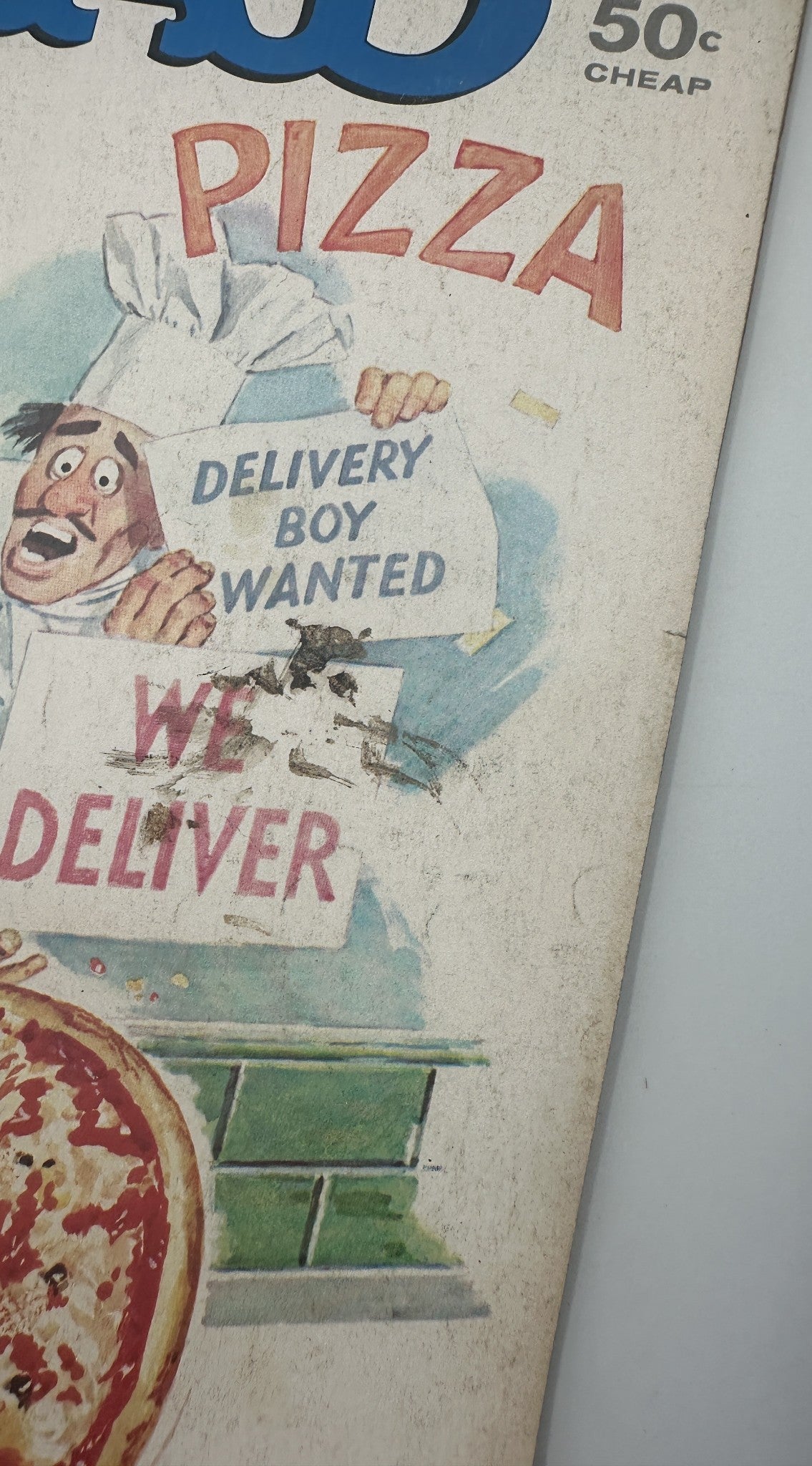 Close-up of the cover of MAD Magazine No. 183 June 1976, focusing on the humorous delivery boy wanted sign and pizza graphic, highlighting the magazine's satirical style.