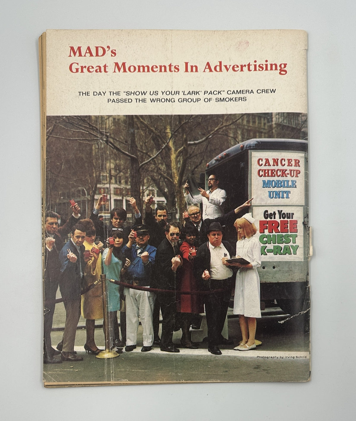 Back cover of MAD Magazine No. 114 October 1967 displaying a humorous scene related to advertising titled 'MAD's Great Moments In Advertising,' featuring a camera crew and a group of smokers.
