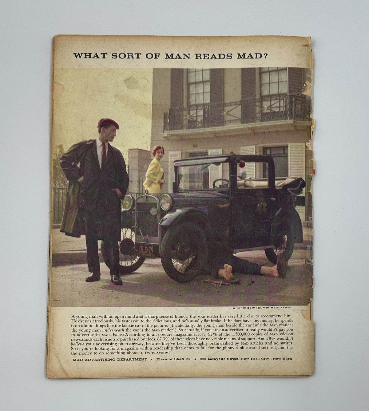Detailed view of the back cover of MAD Magazine #61, March 1961, showcasing a man in a hat next to a vintage car and the text 'What sort of man reads MAD?', highlighting the magazine's humorous advertising style.