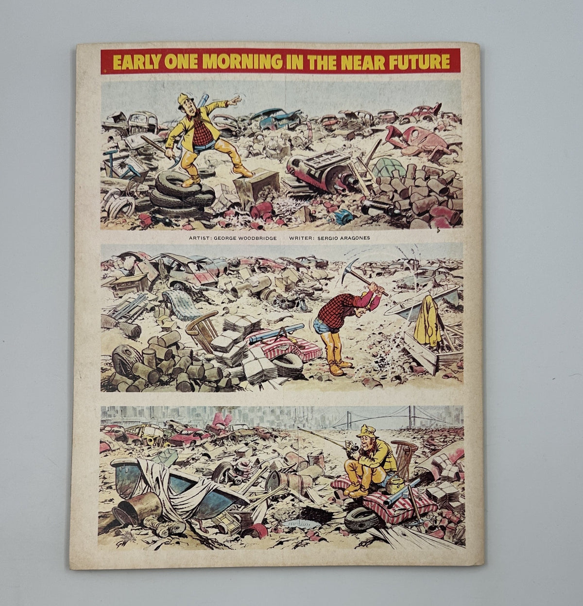 Back cover of MAD Magazine Super Special No. 24, depicting a humorous scene by artist George Woodbridge, featuring a character amidst a chaotic landscape.