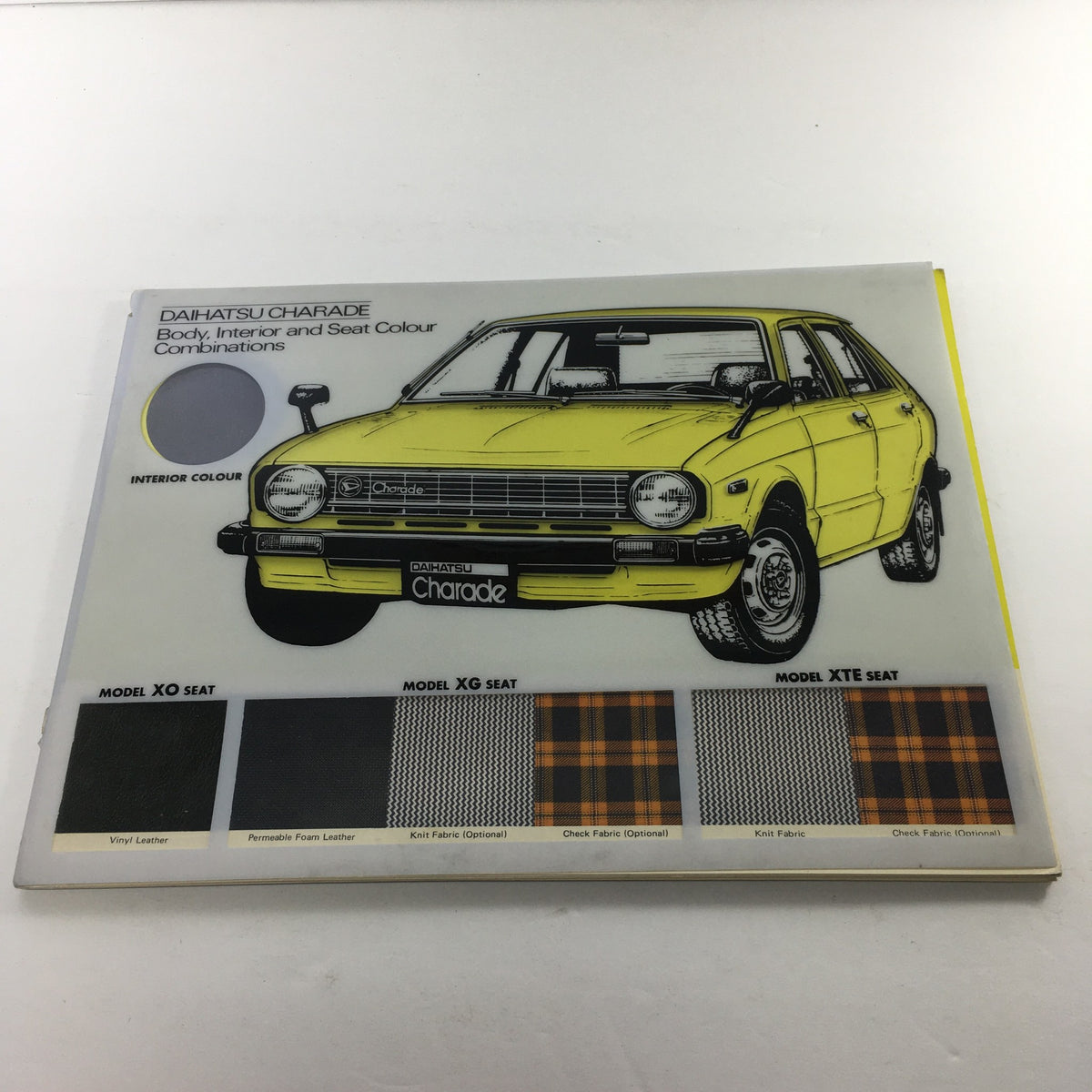 1980s Daihatsu Charade Dealership Brochure showcasing body and interior color combinations with a yellow car illustration.