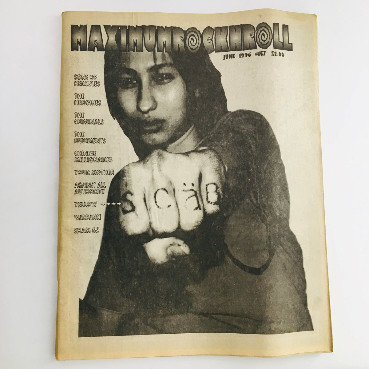 Cover of Maximum RocknRoll Magazine June 1996 #157 featuring Sons Of Hercules, showcasing a punk rock aesthetic and cultural commentary.