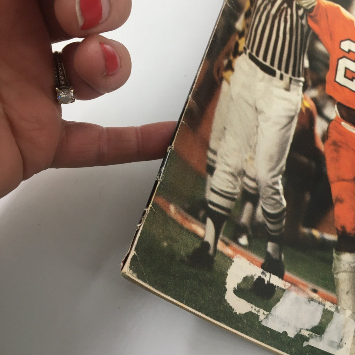 Close-up view of the spine and edge wear of the VTG Sports Illustrated Magazine January 11 1982 featuring Orange Bowl Hero Perry Tuttle, showcasing its collectible condition.