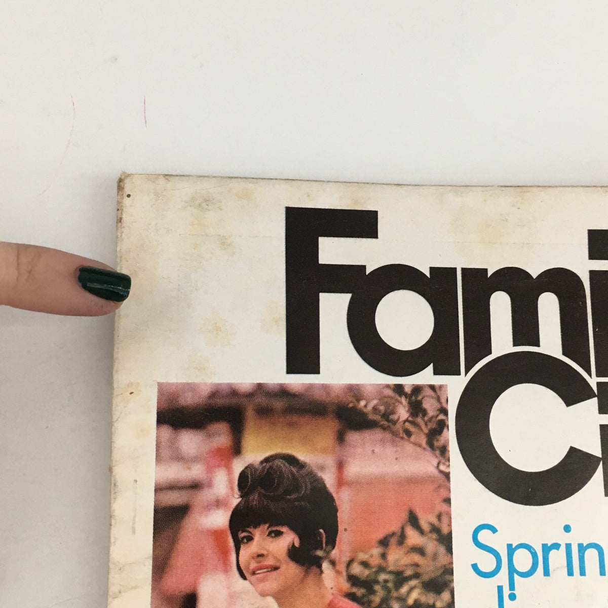 Cover detail of Family Circle Magazine April 1966 featuring spring hairstyles, including a model with a chic hairstyle, demonstrating fashion trends from Paris and the magazine's vintage charm.