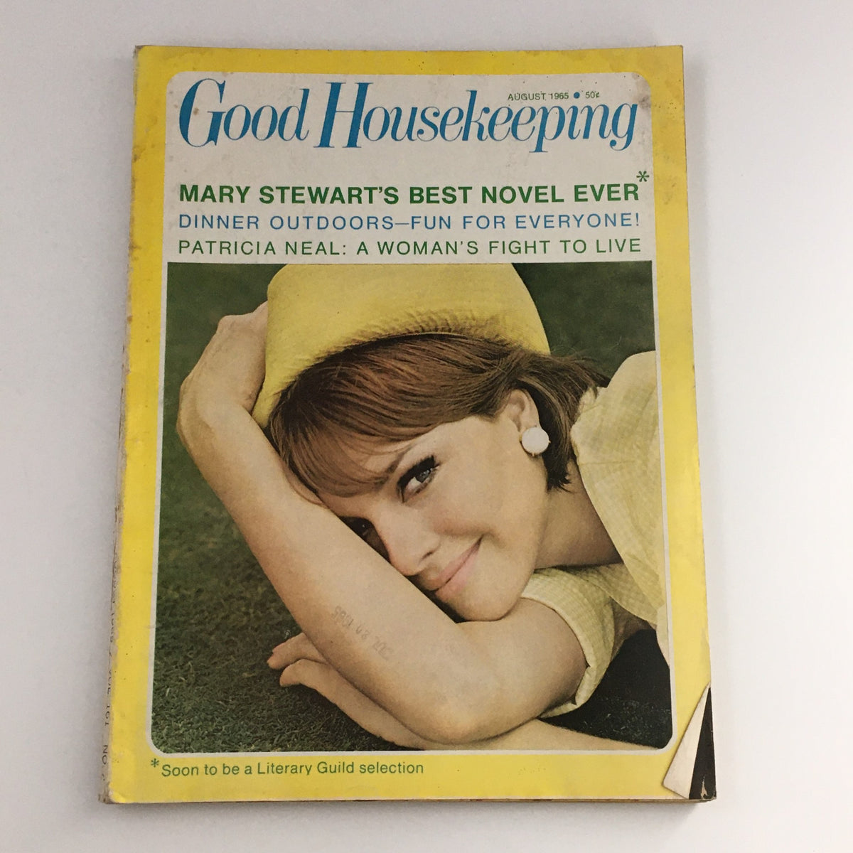 Cover of the Good Housekeeping Magazine August 1965 featuring Mary Stewart's Best Novel, with a vintage photograph of a woman in a yellow hat.