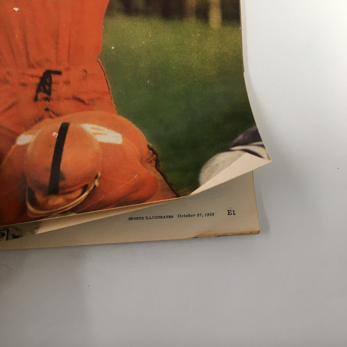 Close-up of the Sports Illustrated Magazine from October 27, 1958, showing a football player in action, highlighting the vintage cover's colors and design.