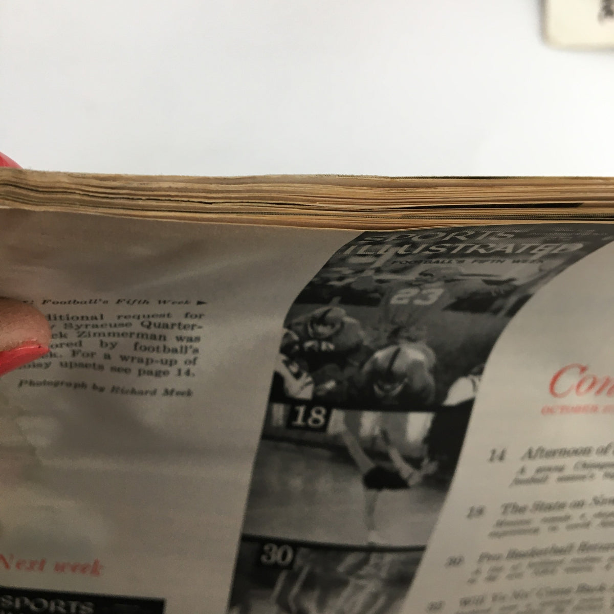 Top view of the Sports Illustrated Magazine from October 27, 1958, displaying pages with slight age wear, emphasizing the vintage nature and historical charm of the publication.